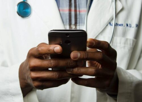 Photo of a doctor holding a cell phone