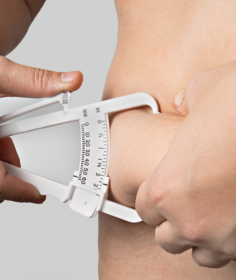 Photo of a person measuring the fat on their body