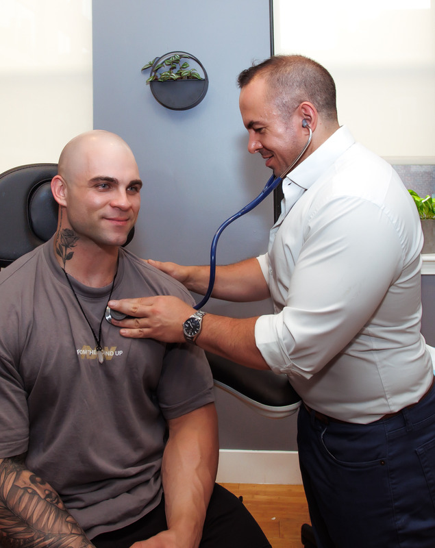 Photo of Dr. Zivich providing primary care services to a patient