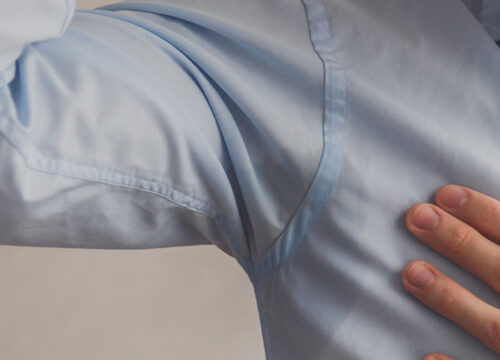 Photo of sweat leaking through a man's dress shirt
